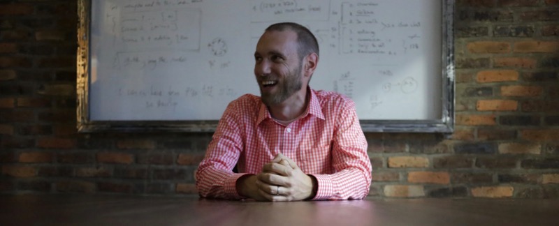 Luke Hartman smiling at a table